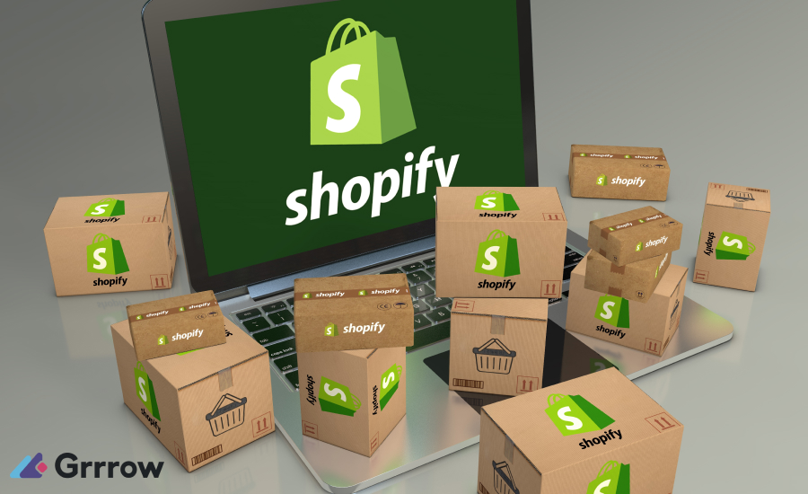 Laptop displaying Shopify interface surrounded by ready-to-ship boxes with Shopify logos, symbolizing online store management and order fulfillment.
